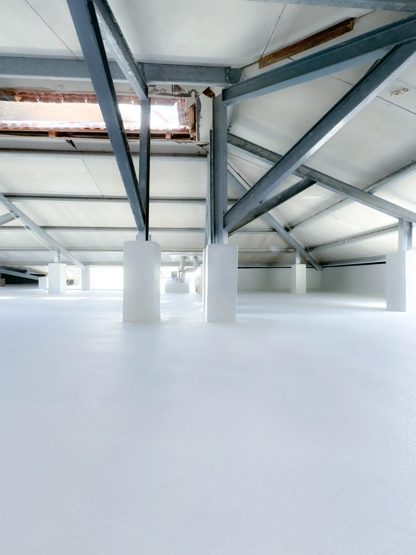Spray-foam insulation and coating inside a Dubai industrial roof structure